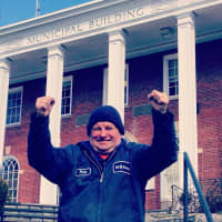 <p>Rocky Tollefsen in front of the Hastings Village Hall on his last day of work.</p>