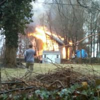 <p>A two-story barn behind a home on Fox Run Road in Norwalk is damaged in a fire Saturday. </p>