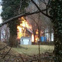 <p>A two-story barn behind a home on Fox Run Road in Norwalk is damaged in a fire Saturday. </p>