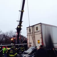 <p>A heavy-duty wrecker pulled the tractor-trailer off the car after a fiery crash on I-95 in Fairfield on Sunday. </p>