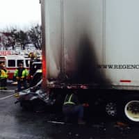 <p>A heavy-duty wrecker pulled the tractor-trailer off the car after a fiery crash on I-95 in Fairfield on Sunday. </p>