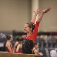 <p>Erika Marr of Ridgefield holds her landing for judges after competing on the balance beam.</p>