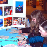 <p>Middlesex Middle School students Alyssa Farrell and Chloe Sheehan participate in the Draw On! Goes Green community art project sponsored by the Darien Arts Center. </p>