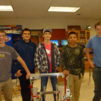 <p>Members of the Ossining High School Robotics Club pose with their robot.</p>
