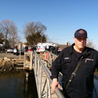 <p>Firefighter Dave Mitkowski with Fairfield Fire Department, Fairfield Police Department and AMR units in background at marine rescue.</p>