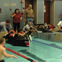 <p>Boats are ready to launch in one of the six heats in the Cardboard Boat Regatta at the Rye Y</p>
