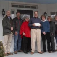 <p>Carol Cioppa, third from left, and members of the Pound Ridge Landmarks and Historic Commission meet the owners of the Nathan Slauson House, one of the landmark homes in Pound Ridge.</p>