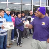 <p>Norwalk Common Council member David Watts leads protesters in a chant for an end to income inequality.</p>