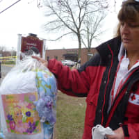 <p>Carolyn Sherwin, a spokeswoman for the American Red Cross, shows a care package given to a four-year-old displaced by a fire. </p>