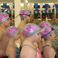 <p>Swimmers get ready to plunge into the pool wearing remodeled swim caps. </p>