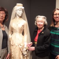 <p>Kaye Leong, Darien Rowayton Bank; left, Babs White, Curator; center,  and Ashley Krauss, A Little Something White Bridal Couture get ready for the exhibit at the Darien Historical Society.</p>