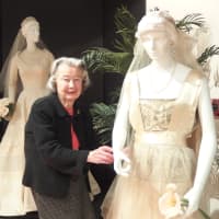<p>Curator Babs White puts the finishing touches on one of the selections at the exhibit.</p>