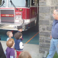 <p>Hastings-on-Hudson Fire Department Chief Rover Russack gives local preschoolers a tour of the firehouse.</p>