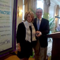 <p>Family Centers President Bob Arnold bestows the Ray of Hope Award to Barbara Netter.</p>