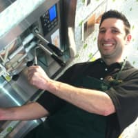 <p>Manager Ryan Ventura pours a frozen yogurt at Peachwave, a new frozen yogurt business in New Canaan. It is located at 11 Forest St.</p>