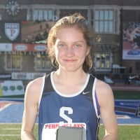 <p>Staples sophomore Hannah DeBalsi accepts her Penn Relays watch after winning the 3,000 meters Thursday in Philadelphia.</p>