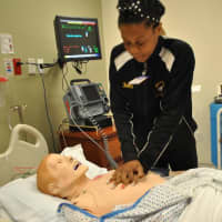 <p>A volunteer practices CPR during the session at Take Our Daughters and Sons To Work day.</p>
