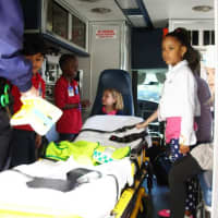 <p>Greenwich Emergency Medical Services show children the inside of an ambulance and how to work a stretcher.</p>
