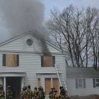 <p>Firefighters stand in front of a New Castle home used for training.</p>