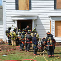 <p>Firefighters stand in front of a New Castle home used for training.</p>