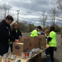 <p>Volunteers at the Fairfield 375 Food Drive help to take all of the goods brought by people in town to have it sorted for packing. </p>