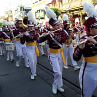 <p>Members of the Harrison High School marching band perform on Main Street USA in Disney World.</p>
