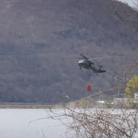 <p>The helicopters practiced scooping up waters from the Hudson in case they need to dump it on fires. </p>
