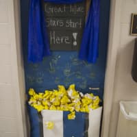 <p>Kindergartners designed their door with a curtain and fingerpaints to represent their spirit and love for the club. </p>