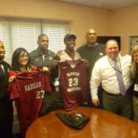 <p>The Martin Luther King High School leadership team with newly signed college student/athlete Dashawn Johnson, center, and Vaughn College basketball coach Ricky McCollum.</p>