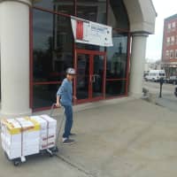 <p>Coby Kilion brings to the post office books that will eventually be shipped to Ghana.</p>