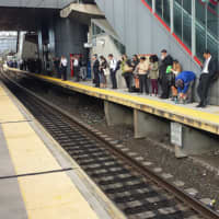 <p>Metro-North commuters line the Stamford train platform </p>