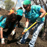 <p>Paula Egan, right, with shovel, from Stamford, and Linda Piacenza, left, from Norwalk, plant a daylilly as part of the construction Friday of a playground in honor of Jesse Lewis, one of the 26 students and staff killed at Sandy Hook in 2012.</p>