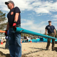 <p>Stamford firefighters, Capt. Jim Kelly, left, and Adam Fullilove, at right, help in playground building at West Beach Friday in honor of Jesse Lewis, one of the 20 students killed at Sandy Hook Elementary School.</p>