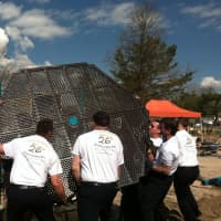 <p>Volunteers help build a playground at West Beach Friday in honor of Jesse Lewis, one of the 20 students killed at Sandy Hook Elementary School.</p>