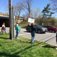<p>People attend the rally at the &#x27;Welcome to Fairfield&#x27; sign just off the northbound Exit 22 ramp on I-95, getting drivers to honk for the cause.</p>