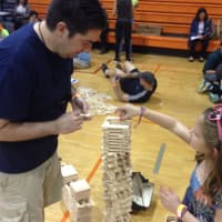 <p>Ed Trissel and his daughter Maddie, 7, create a tall structure with Keva Planks. </p>