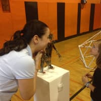 <p>Maria Barajas tells students about her robot, which was made from stereo parts. </p>
