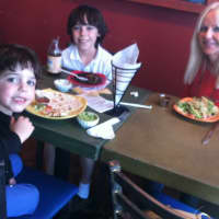 <p>Dawn Konzerowsky enjoys a Mexican meal with her sons, Jack, 5, at left, and Max, 10, center, at Olé Molé at 1030 High Ridge Road on Cinco de Mayo. A former Texas resident she praised the restaurant as having authentic Mexican food.</p>