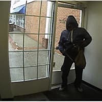 <p>The bank robbery suspect at the entrance of the People&#x27;s United Bank in Darien.</p>