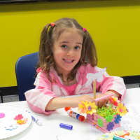 <p>Hayley shows off her flower box that she made at the Tuckahoe Public Library.</p>