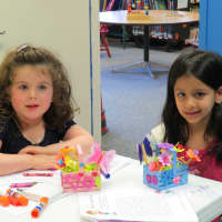 <p>Lily and Lylah took time away from their coloring to pose for a picture at the Tuckahoe Public Library.</p>