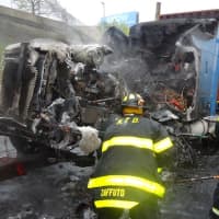 <p>Norwalk firefighters clear melted debris I-95 after the fire.</p>