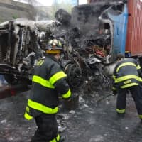 <p>State DOT crews assisted Norwalk firefighters in clearing melted debris.</p>