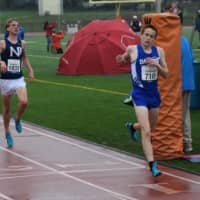 <p>Darien&#x27;s Alex Ostberg hits the finish line with a state record and a second place finish at the Loucks Games in White Plains on Friday, May 9.</p>
