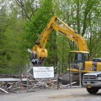<p>Debris from the remains of the building that previously housed Whispering Pines was scooped up.</p>