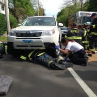 <p>Fairfield and Bridgeport firefighters work together to raise a vehicle in order to pull an injured woman out from under the car.</p>