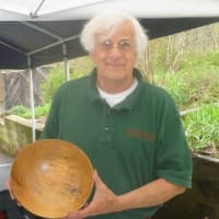 <p>Charles Lazarus shows off one of his handcrafted bowls at Teatown&#x27;s annual plant sale.</p>