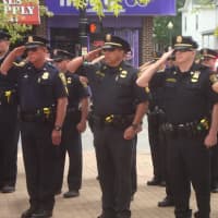 <p>Officers of the Norwalk Police Department salute in honor of those who have died in the line of duty.</p>