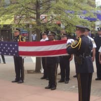 <p>Members of the Norwalk Police Honor Guard take part in a retiring of the colors ceremony.</p>