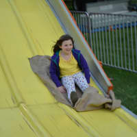 <p>Eight-year-old Maya Bartlett, Pound Ridge, goes on a large slide at the St. Patrick&#x27;s carnival in Bedford.</p>